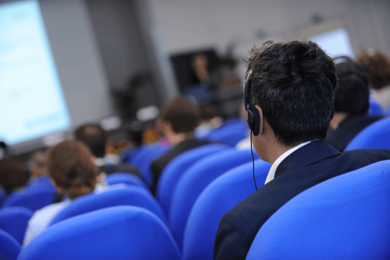 man listens to conference interpreting live feed